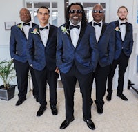 a group of groomsmen in tuxedos